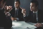 man with handcuffs being interviewed in interrogation room - miranda rights dui concept